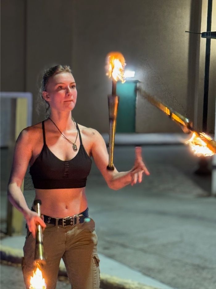 Spread The Flow performer juggling lit fire torches